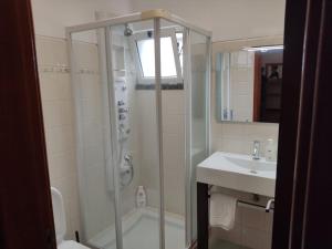 a bathroom with a shower and a sink at Sol e Mar in Ponta do Sol