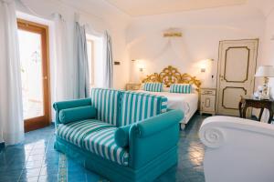 a hotel room with a bed and a couch at Hotel Conca d'Oro in Positano +131 photos