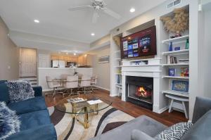 a living room with a fireplace and a tv at Lux Townhouse, Walk to All, Sleeps 6 Adults in Louisville