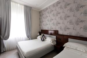 a hotel room with two beds and a wall mural at Glam Luxury Rome in Rome +63 photos