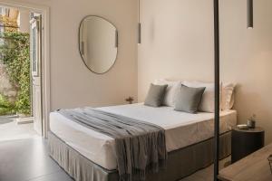 a bedroom with a bed with a mirror on the wall at Marissa's Elegant retreats in Argostoli
