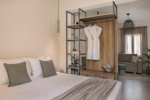 a bedroom with a bed and a dress hanging on a shelf at Marissa's Elegant retreats in Argostoli