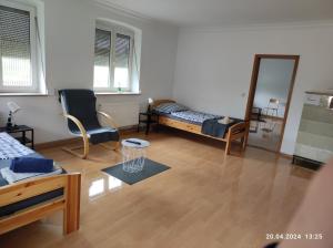 a living room with a bed and a mirror at S-21-Appartments Merklingen Ulm in Merklingen
