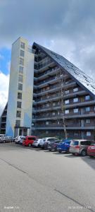 a parking lot with cars parked in front of a building at Schicke Ferien Wohnung mit tollem Ausblick in Schwarzwald. in Villingen-Schwenningen