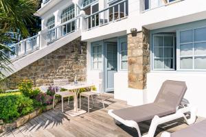 a patio with a table and chairs and a building at Hotel Restaurant Spa du Tumulus Carnac in Carnac