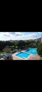 dos fotos de dos piscinas en en Precioso apartamento en Benalmádena, en Benalmádena
