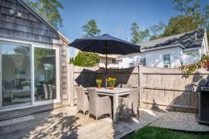 a patio with a table with an umbrella at Stay at Niles Beach in Gloucester