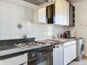 a kitchen with a stove top oven next to a sink at Appartement 8 Couchages - Central & Spacieux - Les Frères de la Loc' in Marseille