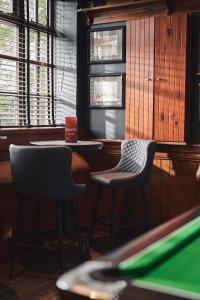 a bar with two chairs and a pool table at The Cults Hotel in Aberdeen