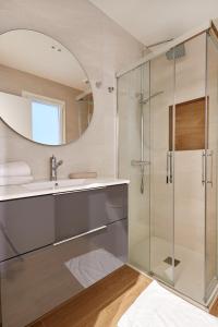 a bathroom with a glass shower and a sink at TuApartamento - Boutique Plaza del Castillo 29 in Pamplona
