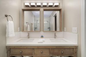 a bathroom with two sinks and a mirror at Lux Townhouse, Walk to All, Sleeps 6 Adults in Louisville