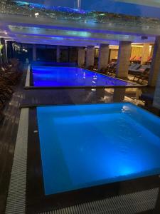 a swimming pool in a hotel at night at Milmari Resort Kopaonik in Kopaonik