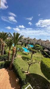 a resort with palm trees and a swimming pool at ALISA COSTA BLANCA in Platja de l'Arenal