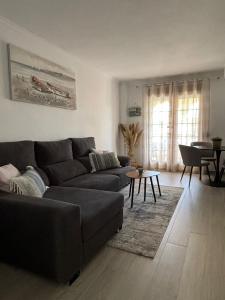 a living room with a couch and a table at ALISA COSTA BLANCA in Platja de l'Arenal