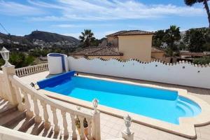 a swimming pool in front of a house at Vista Portet, sleeps 10, Private Pool, Sea Views, Squash, 1 km from El Portet beach in Teulada