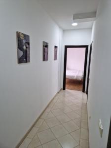 a hallway with three pictures on the wall and a door at Apartman Sonja Trebinje in Trebinje