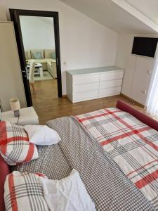 a bedroom with a bed and a dresser and a mirror at Apartman Sonja Trebinje in Trebinje