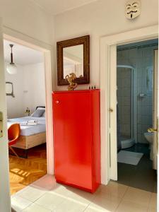 a red cabinet in a room with a bedroom at Dinka Old Town Apartment in Trogir