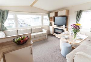 a living room with a couch and a table at Marine Holiday Park in Rhyl