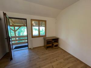 an empty room with a desk and a window at Camping Oaza in Bela Crkva