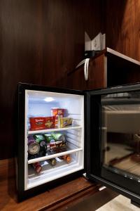 an open refrigerator with food and drinks in it at Esposizione Boutique in Rome