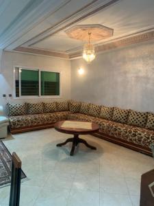 a living room with a couch and a table at Appartement a loué fes in Fès +1 photo