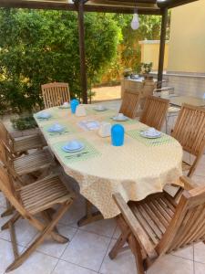 a table with blue cups and plates on it at Le tre terrazze - Gallipoli in Gallipoli