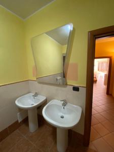a bathroom with two sinks and a mirror at Le tre terrazze - Gallipoli in Gallipoli