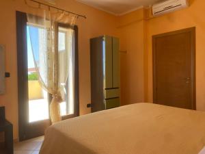a bedroom with a bed and a window at Le tre terrazze - Gallipoli in Gallipoli
