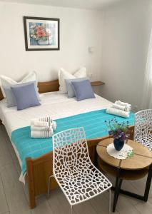 a bedroom with a bed with a table and chairs at Levanda in Trogir