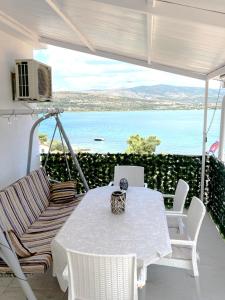 a white table and chairs with a view of the ocean at Levanda in Trogir