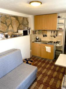 a small kitchen with a couch in a room at Levanda in Trogir