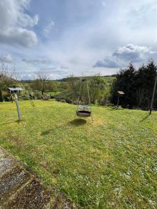 a swing in the middle of a field at Puppenhaus 