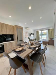 a dining room with a table and chairs in a kitchen at Villa Marinos in Kalamaki