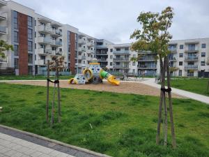 a playground in the middle of a park at Apartament dwupokojowy w Elblągu in Elblag