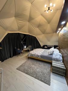 a bedroom with a bed in a tent at GLAXY_GLAMPING in Karakol
