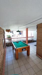 a pool table in the middle of a patio at Maré Alta Hostel in Ubatuba