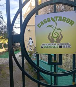 a sign that reads casa tabor behind a gate at Casa Tabor in Ariano Irpino