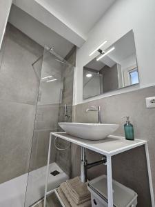 a bathroom with a white sink and a shower at Casa Cesarina in Nardò +37 photos