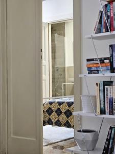 a room with a book shelf with books at Casa Cesarina in Nardò