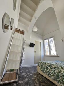 a bedroom with a ladder next to a bed at Casa Cesarina in Nardò +37 photos