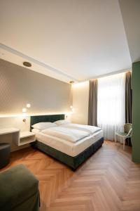 a bedroom with a large bed in a room at Hotel Europa Splendid in Merano