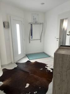 a white room with a black rug on the floor at Ferienwohnung, Thüringen 