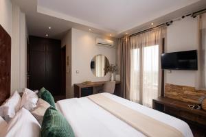 Säng eller sängar i ett rum på Hotel Naiades