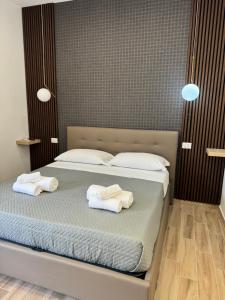 a bedroom with a bed with towels on it at Maison Angioino in Naples