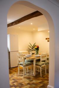 a kitchen and dining room with a table and a refrigerator at Characterful Cottage - Sleeps 6 - Parking - High Street in Marlborough