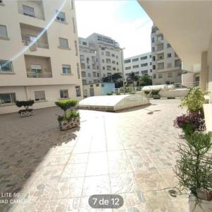 a courtyard of a building with a large building at val fleuri résidences Tanger in Tangier