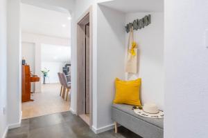 a living room with a couch and a yellow pillow at Apartman L&L in Makarska +33 photos