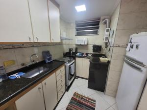a small kitchen with a sink and a refrigerator at SuhcasaCopacabana 54 Wonderful in Rio de Janeiro