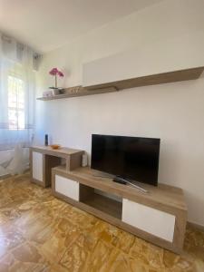 a living room with a flat screen tv at Sole , Neve e Relax in Clusone
